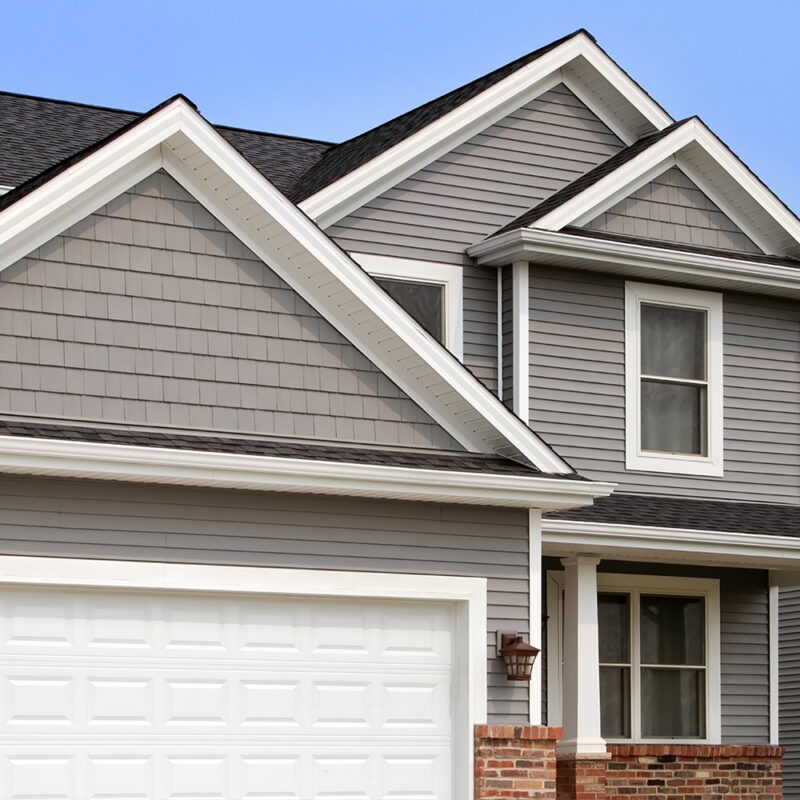 A house with two garage doors and a white door.